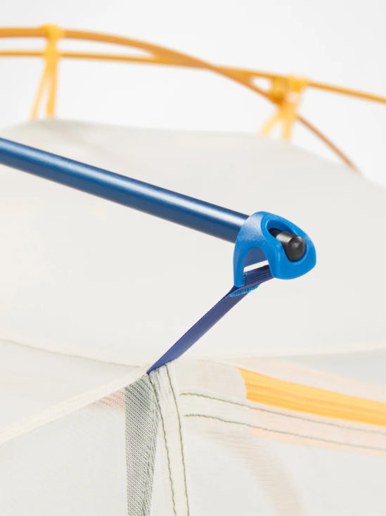 Close-up of a tent's metal pole joint with a blue plastic connector, attached to a white fabric canopy with orange support bars visible in the background.